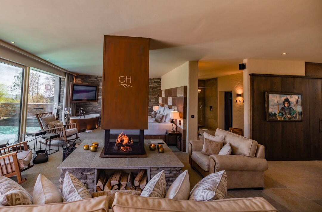 Cozy Swiss chalet living room with a stone fireplace and wooden beams